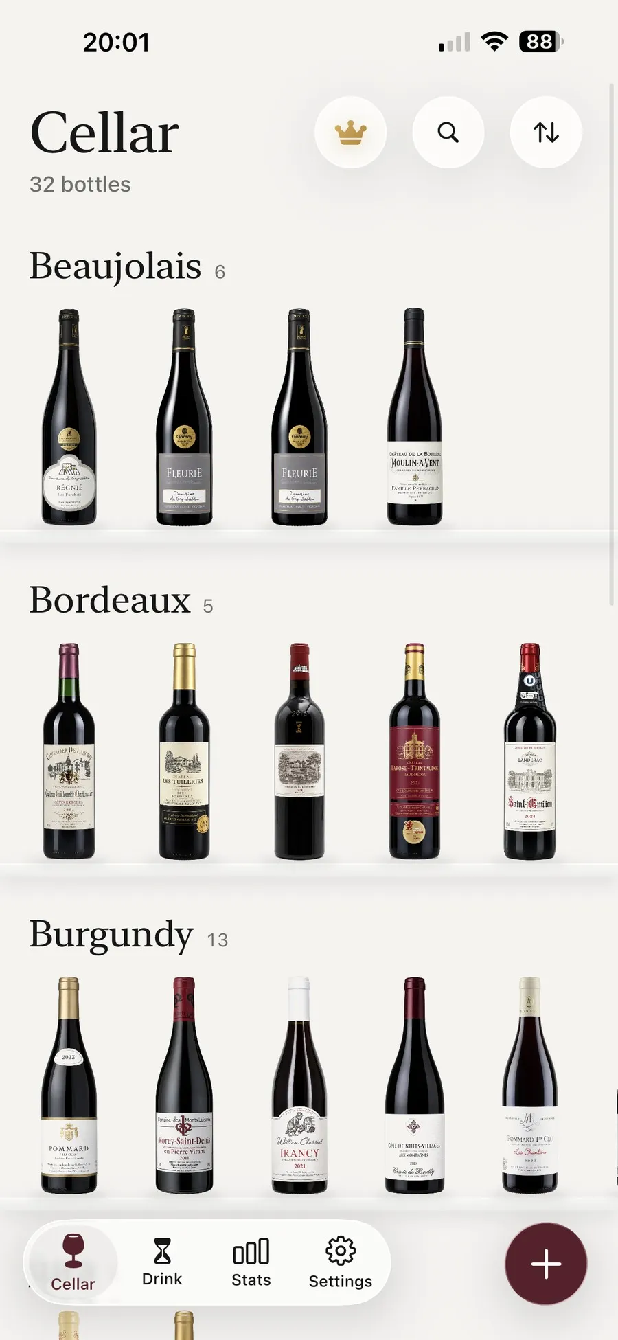 The Kav cellar laid out as a shelf, with one row of Beaujolais, one of Bordeaux and one of Burgundy, the bottles standing on glass shelves